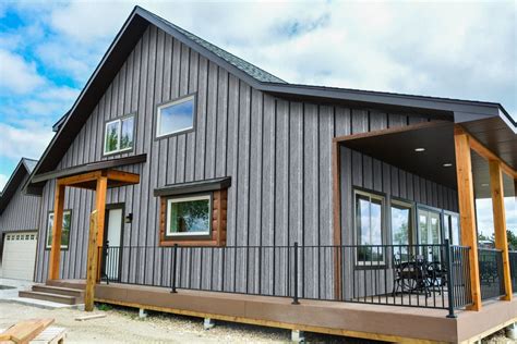 metal roof on grey house|gray siding black windows.